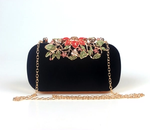Exquisite detail of black velvet evening bag with colorful rhinestone floral metal clasp