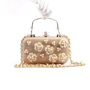 Elegant gold clutch bag with 3D floral pearls, metallic handle and chain strap