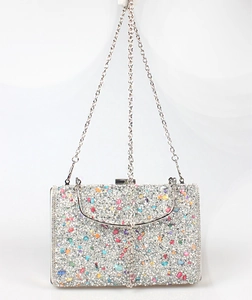 Detail of mermaid clutch bag featuring colorful rhinestones and silver metal chain strap