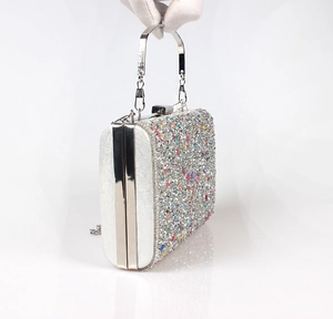 Detailed shot of sparkling rhinestone evening clutch with silver handle and chain
