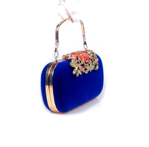 Detailed view of dark blue velvet clutch with colorful crystal floral rhinestones