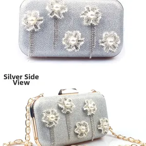 Close-up of silver evening clutch featuring lace flowers, pearls and tassel rhinestones