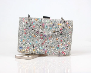 Detailed view of rhinestone evening clutch with colorful gems and metal handle