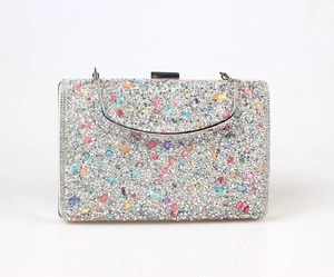 Close-up of silver evening clutch bag with colorful rhinestones and crystal stones