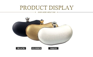 Detailed close-up of bean-shaped evening clutches with rhinestone clasps in black and gold