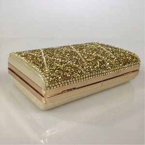 Detailed top view of champagne gold evening clutch bag with geometric diamond patterns