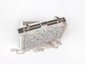 Sparkling silver rhinestone evening bag showing interior capacity with a smartphone
