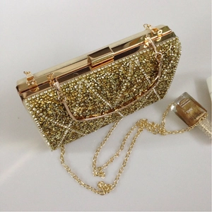 Detail view of luxury golden rhinestone evening clutch with diamond lattice pattern