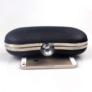 Elegant black leather evening clutch bag featuring a large crystal clasp and silver metal trim