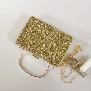 Top view of gold rhinestone evening clutch with diamond geometric patterns and metal handle