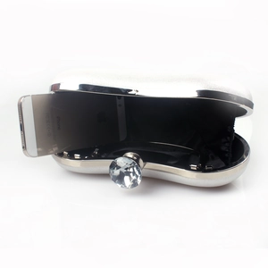 Elegant white pearl dinner clutch with crystal buckle showing internal phone storage capacity