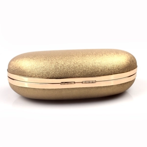 Detail of a gold oval clutch bag featuring a shimmering texture and metallic trim
