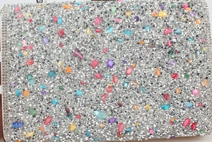 Macro detail of colorful mosaic rhinestones and gems on a mermaid evening clutch bag