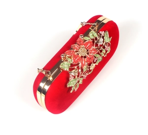 Detailed view of red velvet evening clutch featuring intricate crystal floral patterns
