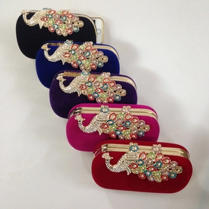 Close-up of velvet evening clutch bags with peacock crystal rhinestones in multiple colors