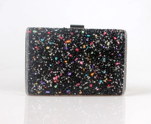 Detail of evening clutch featuring black rhinestones and multi-color crystal stones