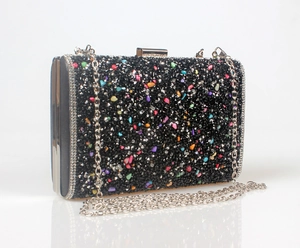 Detailed side view of black mermaid evening clutch with colorful rhinestones and chain strap