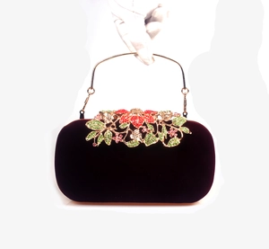 Macro view of burgundy velvet clutch with crystal flower and gold metal handle