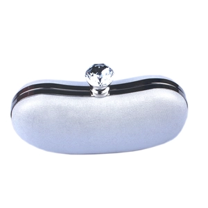 Detail of silver evening clutch with sparkling crystal clasp and metallic frame