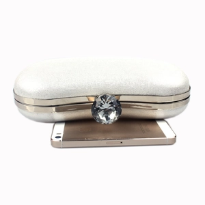 Silver clutch bag with diamond clasp closure shown next to a smartphone for size reference