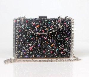Macro detail of mermaid evening bag with colorful rhinestones and silver metal chain
