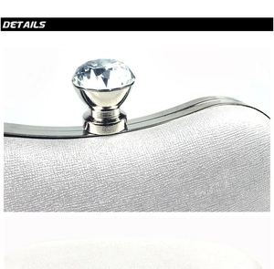 Close-up of sparkling crystal clasp on silver metallic textured evening clutch bag