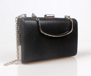 Detail of black satin evening clutch with silver handle and detachable chain strap