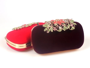 Macro detail of luxury velvet evening bags featuring rhinestone floral metal clasps