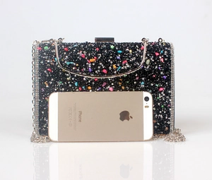 Macro shot of rectangular evening clutch with black rhinestones and colorful crystals