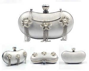 Detailed views of silver evening clutch with pearl flower accents and long fringe tassels