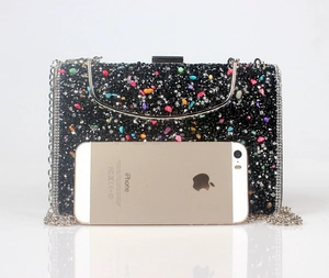Size comparison of a black rhinestone evening clutch with colorful crystals and phone