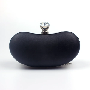 Detail of black Saffiano leather evening clutch with large crystal clasp and curved shape