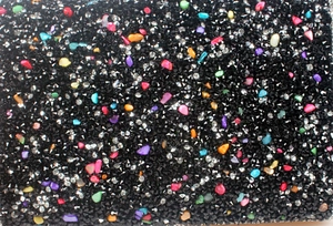 Macro detail of evening clutch featuring black rhinestones and colorful gemstone inlay