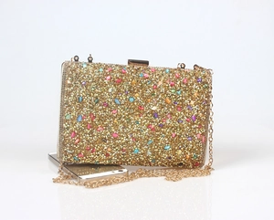 Detailed shot of a luxury gold evening clutch with colorful rhinestones and size reference