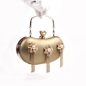 Golden evening clutch bag with crystal tassels, floral decor and pearl accents