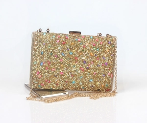 Detailed view of luxury colorful rhinestone evening clutch with gold chain and size scale