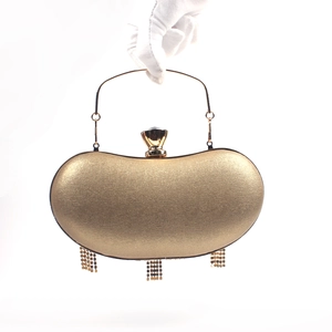Golden crescent evening bag with metallic texture, circular handle and beaded tassels