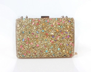 Detailed macro view of mermaid style dinner bag with colorful rhinestones and gold chain