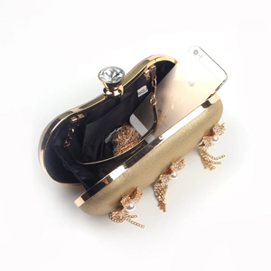 Golden hard shell evening clutch with crystal clasp and pearl rhinestone tassels