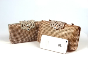 Dettaglio della pochette da sera con strass champagne, chiusura a corona e catena
