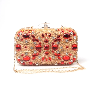 Detailed macro view of red crystals and gold hardware on luxury beaded evening clutch bag
