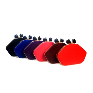 Group of hexagonal velvet evening bags in six colors with gold frames and jewel clasps