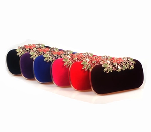 Detailed lineup of multi-color velvet evening bags with crystal leaf metal clasps