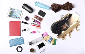 Open gold evening clutch showing capacity for phone, makeup, and essentials with pearl tassel