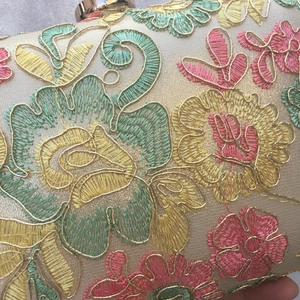 Elegant champagne evening clutch bag with colorful floral embroidery and metal frame