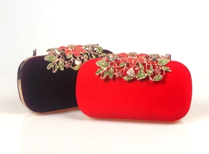 Detail of red and purple velvet clutch bags with crystal flower and leaf ornaments