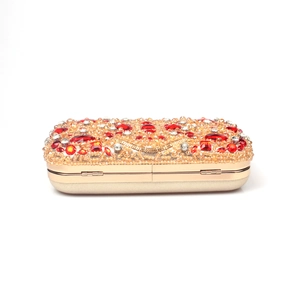 Detailed front view of champagne gold evening clutch with red and white crystals