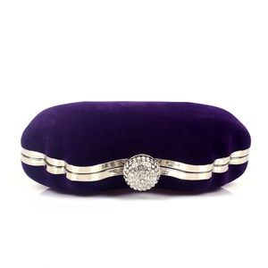Macro shot of purple velvet texture and sparkling rhinestone-encrusted ball clasp