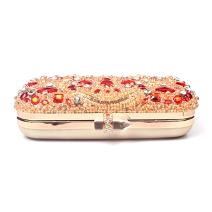 Luxury gold dinner clutch bag featuring red and white crystals with orange beaded surface
