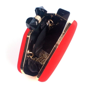 Red velvet lip-shaped clutch bag with gold frame and chain strap, showing phone storage space